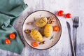 Delicious homemade baked hasselback potatoes with garlic and rosemary on a plate. Top view Royalty Free Stock Photo