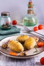 Delicious homemade baked hasselback potatoes with garlic and rosemary on a plate. Vertical view Royalty Free Stock Photo