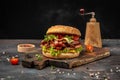 Delicious homemade burgers of beef, cheese and vegetables on a wooden board, Hamburger. Fast food concept Royalty Free Stock Photo