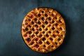 Delicious Homemade Cherry Pie with a Flaky Crust on dark background. Top view. American pie. Cherry dessert. Flatlay