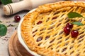 Delicious Homemade Cherry Pie, Flaky Crust, piece on a plate and the whole homemade cherry pie, place for text, top view Royalty Free Stock Photo