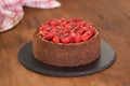 Delicious homemade chocolate cheesecake decorated with cherry sauce. Royalty Free Stock Photo