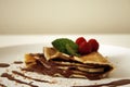 Chocolate pancake with raspberries and mint leafs Royalty Free Stock Photo