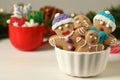 Delicious homemade Christmas cookies in bowl on white wooden table against blurred festive lights. Space for text Royalty Free Stock Photo