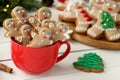 Delicious homemade Christmas cookies in cup on white wooden table. Space for text Royalty Free Stock Photo