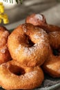 Delicious homemade crumpets or fried donuts sprinkled with powdered sugar in hard light, close up Royalty Free Stock Photo