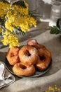 Delicious homemade crumpets or fried donuts sprinkled with powdered sugar on textured table background Royalty Free Stock Photo