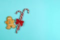 Delicious homemade Christmas cookies in the form of a man and lollipops on a blue background Royalty Free Stock Photo