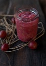 Compote with gooseberries in a glass jar on wooden background Royalty Free Stock Photo