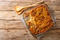 Delicious homemade Jerusalem kugel with noodles, raisins, cinnamon and sugar close-up in a glass bowl. Horizontal top view