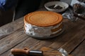 Delicious homemade layer cake with cream on wooden table