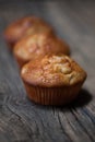 Delicious homemade muffins over wooden board