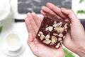 A delicious homemade nutty brownie with earl grey in the afternoon tea time. On beautiful hands.