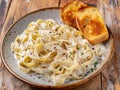 Delicious homemade pasta dish with creamy sauce and garlic bread