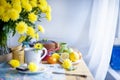 Delicious homemade pastries with poppy seeds and fresh berries on the breakfast table. A big bouquet of yellow flowers. Autumn Royalty Free Stock Photo