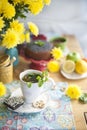 Delicious homemade pastries with poppy seeds and fresh berries on the breakfast table. A big bouquet of yellow flowers. Autumn Royalty Free Stock Photo