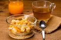 Delicious homemade peach cobbler in transparent glass bowl on bamboo mat