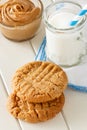 Delicious homemade peanut butter cookies with mug of milk. White wooden background. Healthy snack or tasty breakfast concept. Royalty Free Stock Photo