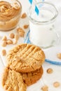 Delicious homemade peanut butter cookies with mug of milk. White wooden background. Healthy snack or tasty breakfast concept Royalty Free Stock Photo