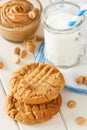 Delicious homemade peanut butter cookies with mug of milk. White wooden background. Healthy snack or tasty breakfast concept Royalty Free Stock Photo