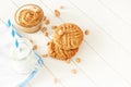 Delicious homemade peanut butter cookies with mug of milk. White wooden background. Healthy snack or tasty breakfast concept. Royalty Free Stock Photo