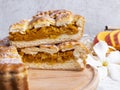 Delicious homemade pie tart with pumpkin, cabbage filling, close up, round, cut piece