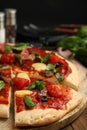 Delicious homemade pita pizza on wooden table, closeup