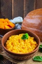 Delicious homemade pumpkin porridge on wooden background. Healthy vegan food Royalty Free Stock Photo