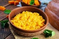 Delicious homemade pumpkin porridge on wooden background. Healthy vegan food Royalty Free Stock Photo