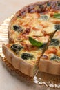 Delicious homemade quiche with salmon and broccoli on beige table, closeup Royalty Free Stock Photo