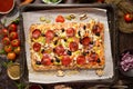 Delicious Homemade rectangular pepperoni pizza on a rustic table with ingredients Royalty Free Stock Photo