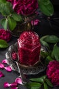 Delicious homemade rose jam in jar with rose flowers