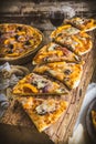 Delicious homemade salami pizza served on a rustic old wooden beam on a rustic wooden table Royalty Free Stock Photo