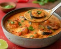 Delicious Homemade Shrimp Curry in Pan with Lime and Herbs on Red Background Traditional Seafood Cuisine Concept Royalty Free Stock Photo