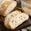 Delicious homemade sliced Italian ciabatta bread on a wooden cutting board.