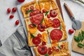 Delicious homemade square pizza with vegetables on white