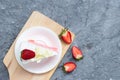 Delicious homemade strawberry cake and fresh milk cream in white dish on gray stone table rustic style. Top view with copy space Royalty Free Stock Photo