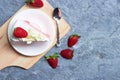 Delicious homemade strawberry cake and fresh milk cream in white dish on gray stone table rustic style. Top view with copy space Royalty Free Stock Photo