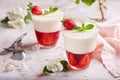 Layered dessert in glass with vanilla panna cotta and jelly with strawberries