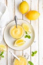 Homemade tangy lemon curd decorated with fresh fruit in a glass jars on rustic wooden background Royalty Free Stock Photo