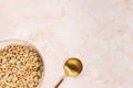 Delicious honey cheerios cereal in a bowl and golden spoon on pink background. Top view, copy space Royalty Free Stock Photo