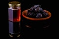 Delicious honey in jar and Ajwa dates on black background Royalty Free Stock Photo