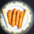 Delicious hot Baby corn baji with fresh baby corn placed in plate with black backgrounds and packed with vital antioxidants and