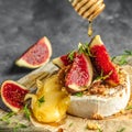 Delicious hot baked camembert with figs, nuts and honey, Restaurant menu, dieting, cookbook recipe top view Royalty Free Stock Photo