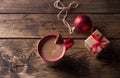 Delicious Hot Chocolate Cocoa Drink In Red Mug With Christmas Red Ball And Gift On Wooden Background, Traditional Winter Drink
