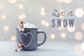 Delicious hot chocolate with marshmallow and litle snowmans on grey stone background. New Year bokeh.