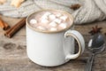 Delicious hot cocoa drink with marshmallows in cup on wooden table Royalty Free Stock Photo