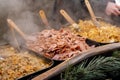 Delicious hot dishes outdoors traditional festive market catering service, food preparation, cooking and serving hot steamy food,