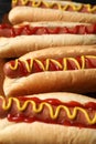 Delicious hot dogs with mustard and ketchup on wooden table, closeup Royalty Free Stock Photo