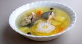 Delicious hot fish soup from sea fish in a white plate on a gray table Royalty Free Stock Photo
